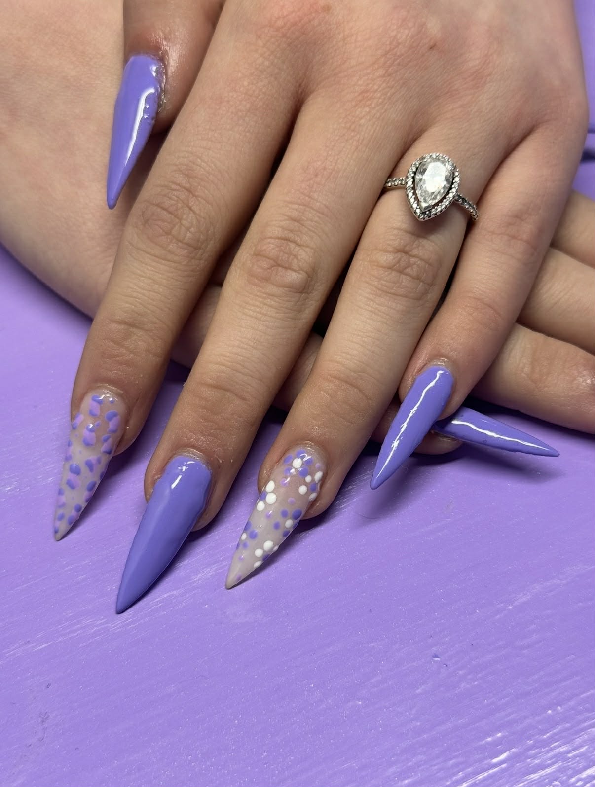 Lavender stiletto nails with dot accents