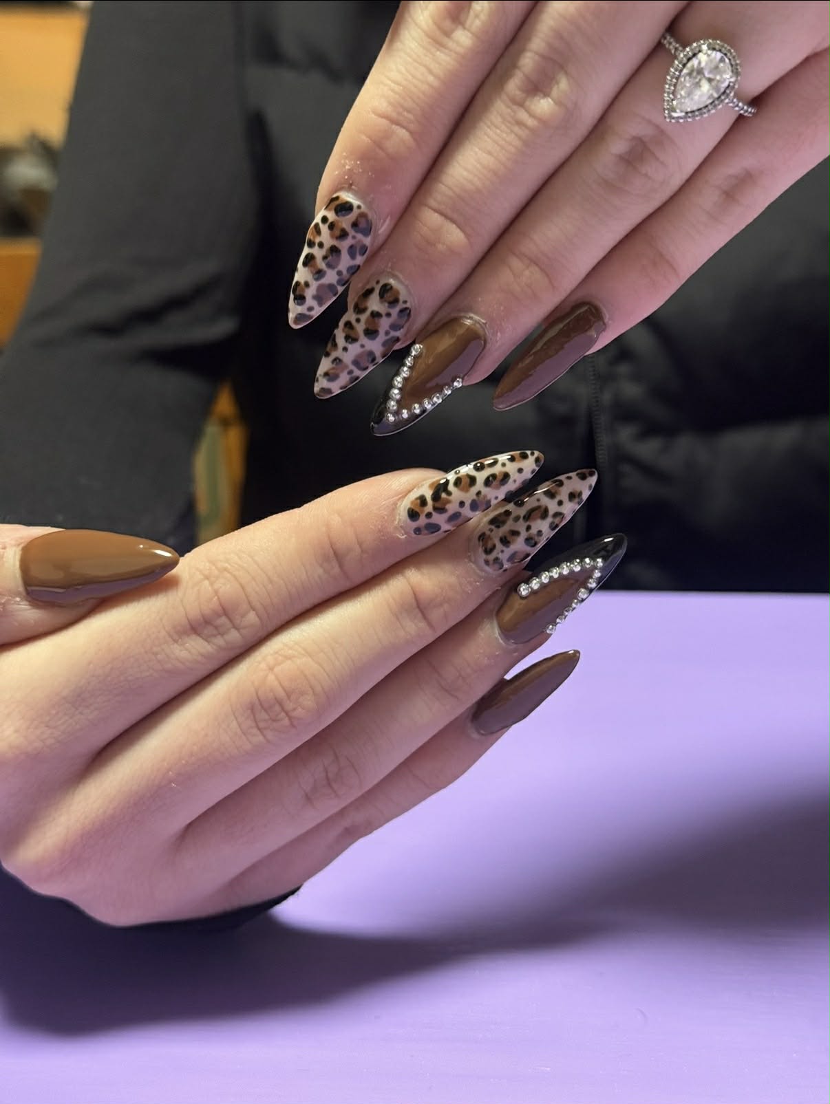 Leopard-print stiletto nails with rhinestone accents